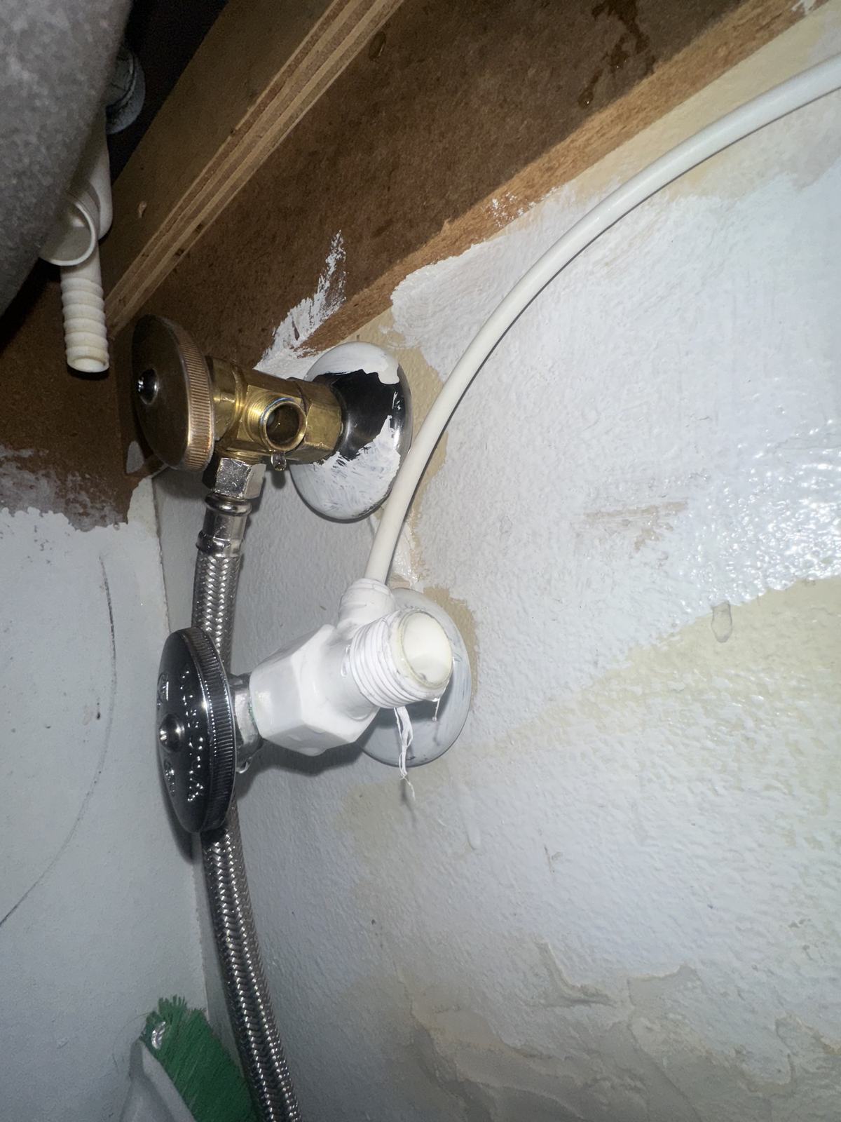 Exposed shut-off valves and supply line on a water-stained wall – 77 Rapid Restore