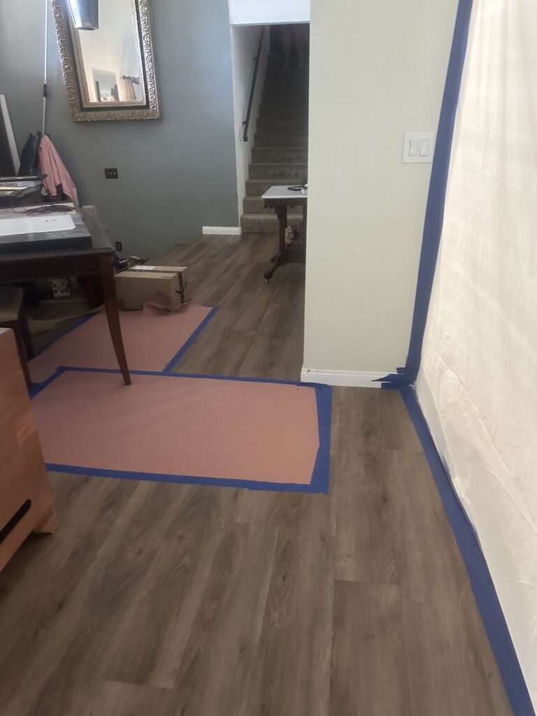 Floor protection and a taped plastic barrier set up before repair work – 77 Rapid Restore