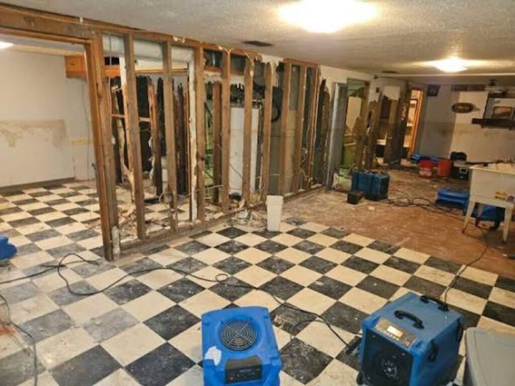 Interior walls opened to the studs with dehumidifiers drying a large water loss – 77 Rapid Restore