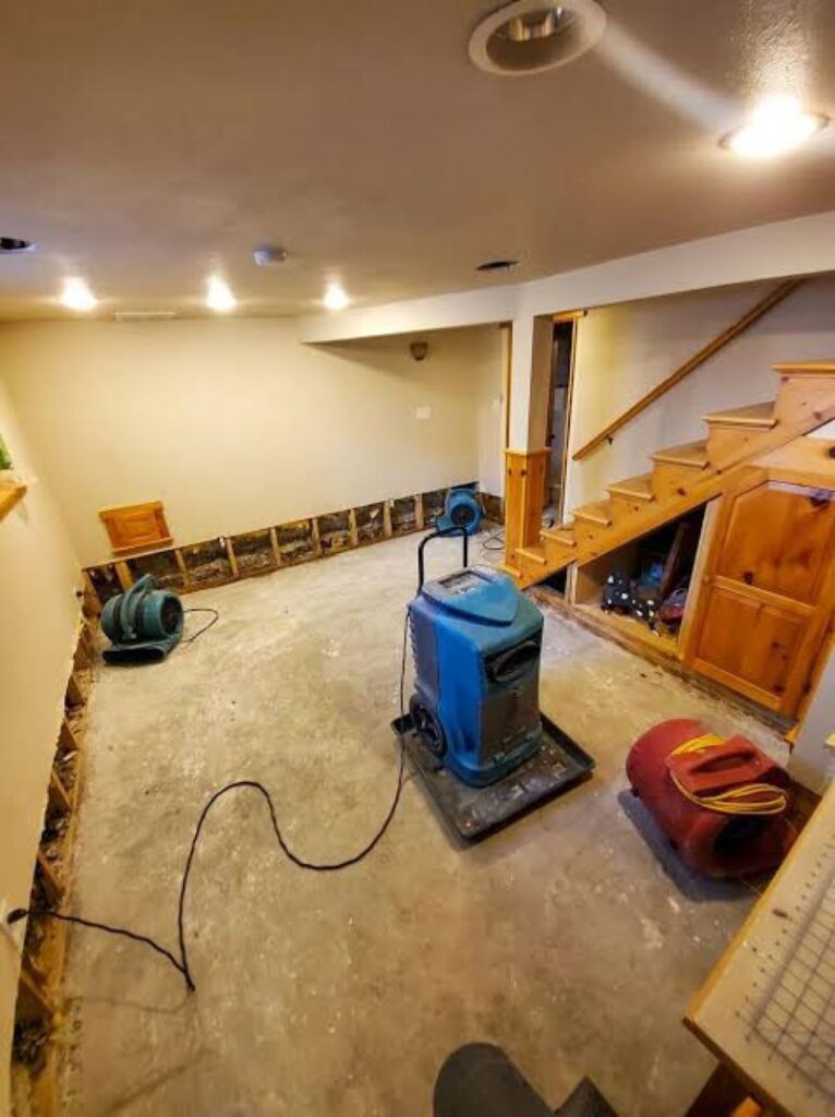 Dehumidifier and air movers drying a finished basement after a supply-line leak – 77 Rapid Restore